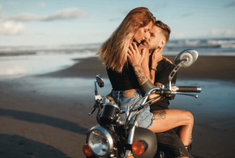 Couple on a motorcycle at the beach